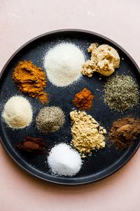 plate with small piles of dry spices for homemade jamaican jerk spice blend