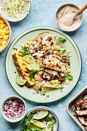 jerk chicken tacos topped with onion, pineapple, cabbage, cilantro and jerk aioli. served with a wedge of grilled pineapple