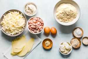 Ingredients laid out cheese, ham, eggs, cream cheese, mayonnaise