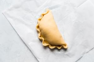 unbaked Keto Homemade Ham And Cheese Hot Pocket on parchment paper