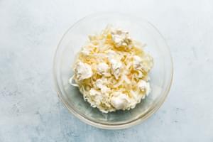 cream cheese and shredded cheese in a bowl