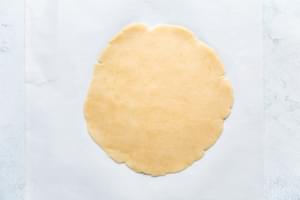 keto hot pocket dough rolled out on parchment paper