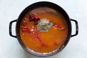 chicken stock, canned tomatoes and tomato paste and Italian seasoning added to a soup pot