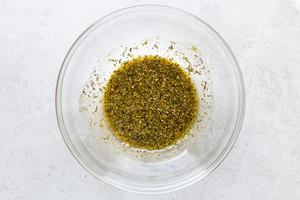 olive oil, oregano, thyme, garlic powder, salt, and pepper in a bowl.
