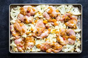 cauliflower and mango chutney chicken on a baking sheet