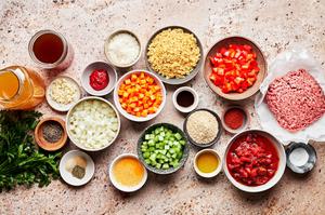 prepped ingredients for homemade meatball soup in prep bowls on the counter