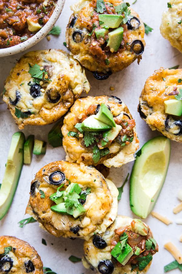 sausage and cheese breakfast egg muffins with avocados and a bowl of salsa