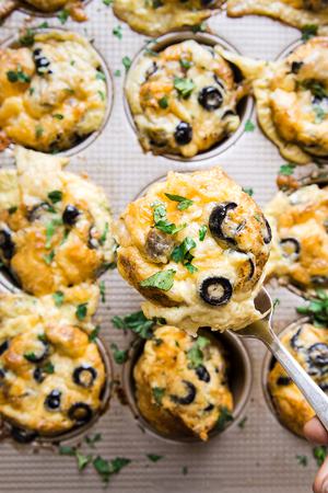 fork scooping Mexican style egg muffin out of muffin pan
