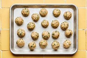 raw ground chicken miso meatballs on a rimmed sheet pan