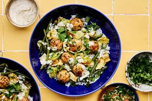 Chicken meatballs served on top of white rice, roasted green beans and cabbage and drizzled with miso ranch sauce