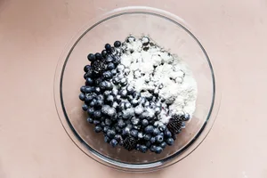mixed berries in a bowl with sugar, salt, flour, lemon juice and cinnamon
