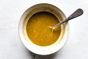 moroccan salad dressing in a bowl with a spoon