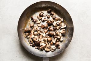 quartered mushrooms browning in a skillet