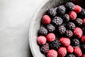 frozen berries in a pie dish for adding to norwegian rice pudding