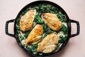 one-pot chicken with creamed kale made with parmesan, heavy cream, whole grain mustard in a skillet