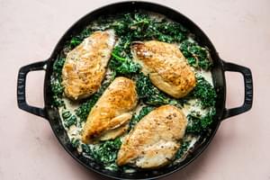one-pot chicken with creamed kale made with parmesan, heavy cream, whole grain mustard in a skillet