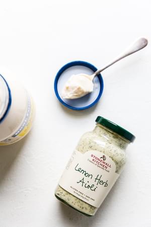 a jar of mayonnaise and mayo on a spoon a jar of aioli