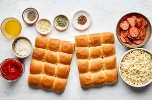 Hawaiian rolls, mozzarella, Parmesan, pepperoni, pizza sauce, spices and butter in prep bowls to make pizza sliders