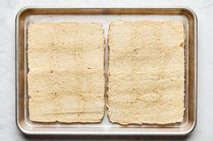 24 Hawaiian rolls sliced horizontally on a baking sheet