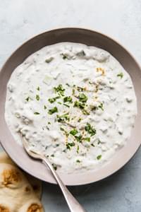 easy raita in ceramic bowl with a spoon