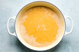 coconut curry broth in a white skillet