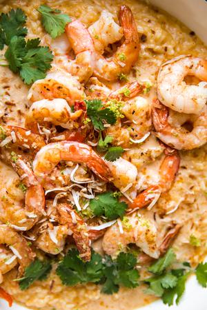 close up of crispy shrimp over red curry risotto