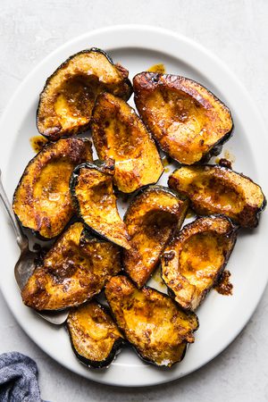 roasted acorn squash on a platter, the perfect cozy fall side dish
