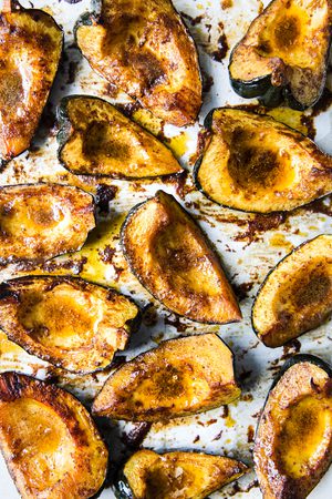 Roasted acorn squash halves seasoned with butter, brown sugar, salt, chili powder, and cumin, baked to golden perfection