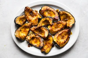 roasted acorn squash on a platter, the perfect cozy fall side dish