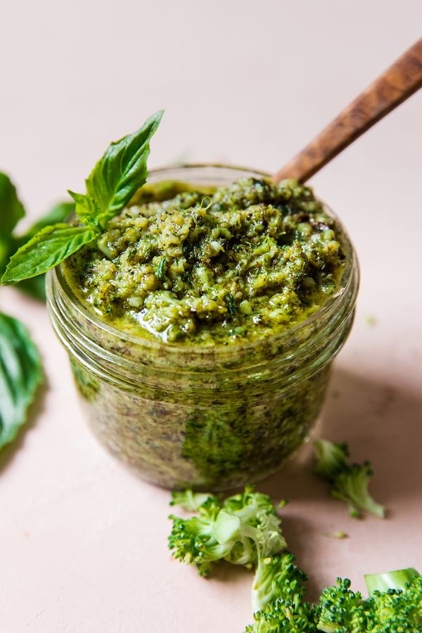 roasted broccoli pesto in a jar topped with fresh basil