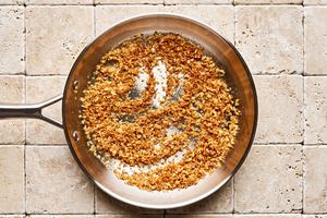 panko being toasted in melted butter in a skillet