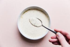 dressing made of olive oil, mayonnaise, dried dill, salt, pepper, lemon juice and stone ground mustard in a bowl.