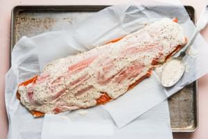 1 salmon filet spread with marinade for Salmon Niçoise Salad on a sheet pan