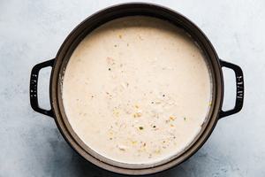 large cast iron pot with seafood bisque