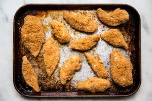 baked homemade shake and bake chicken just out of the oven on a baking sheet