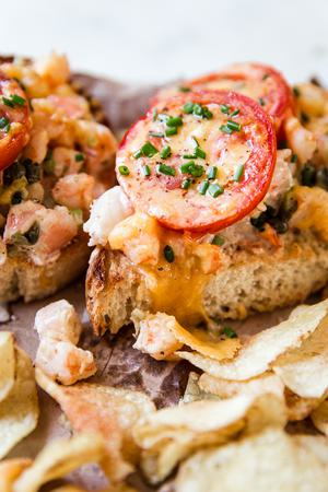 side of shrimp melt showing melted yellow cheese