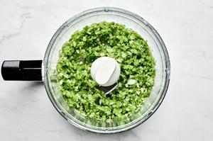 bell pepper, onion, jalapeño, and garlic being pulsed in a food processor