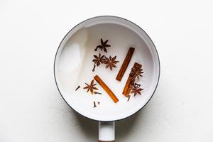sauce pan of sugar with water cinnamon sticks, star anise and cloves