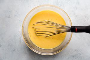 eggs, milk, salt and pepper whisked together in a bowl to make egg cups