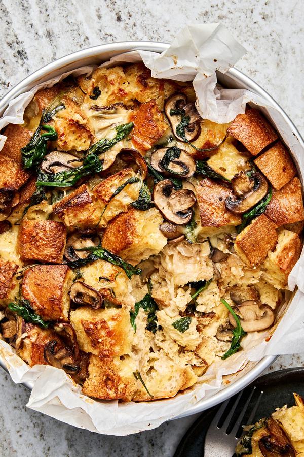 spinach mushroom strata in a parchment lined baking pan