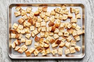 toasted cubed bread on a baking sheet