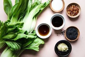 ingredients for stir fired baby bok choy: sesame oil, garlic, soy sauce, salt, red pepper flakes and sesame seeds