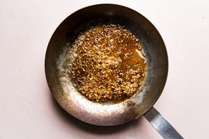 stainless steel skillet with garlic and soy sauce