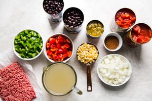 ground beef, black beans, bell peppers, onion, green chiles, stock, diced tomatoes, corn and taco seasoning in prep bowls