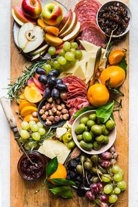 The Perfect Cheese Board with salami, grapes, olives and cheese