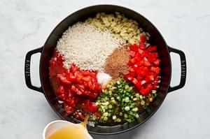 vegetarian stuffed pepper filling cooking in a skillet made with rice, beans, corn, onion and spices