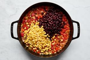 vegetarian stuffed pepper filling cooking in a skillet made with rice, beans, corn, onion and spices
