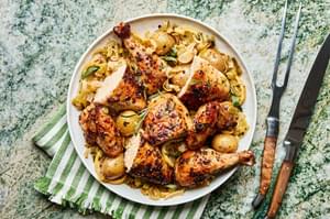 Tender segments of whole roast chicken served alongside crispy potatoes and caramelized leeks, a cozy and delicious dish.