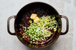 bacon, butter, celery and leeks cooking in a pot to make rich and velvety wild mushroom chowder