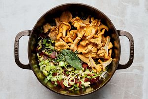 chantrelle mushrooms and cozy spices added to a pot with bacon, leeks and celery to make wild mushroom chowder